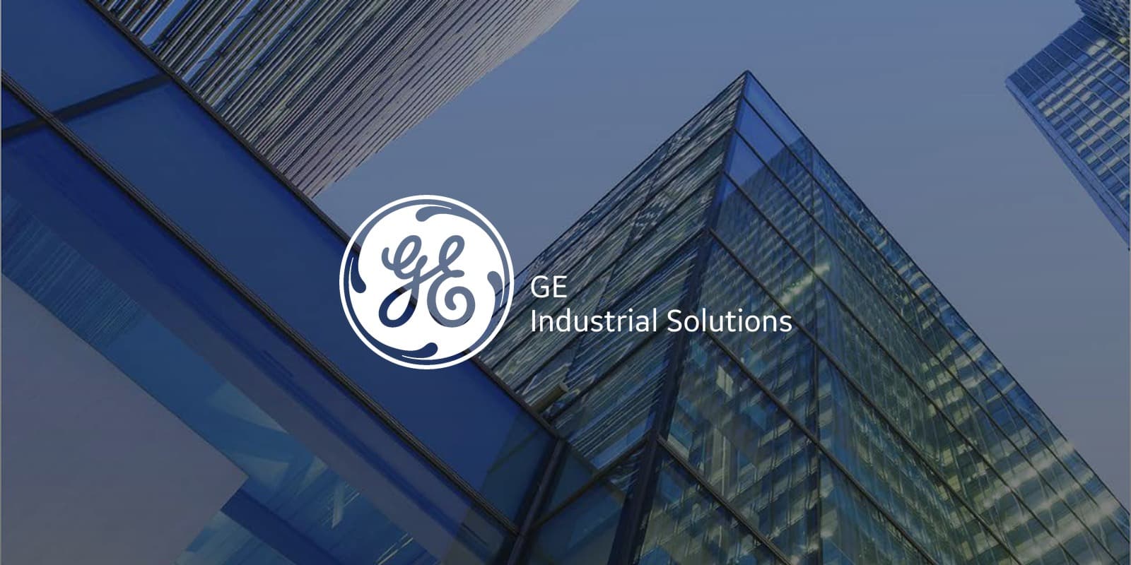 GE Industrial Solutions logo over glass office towers