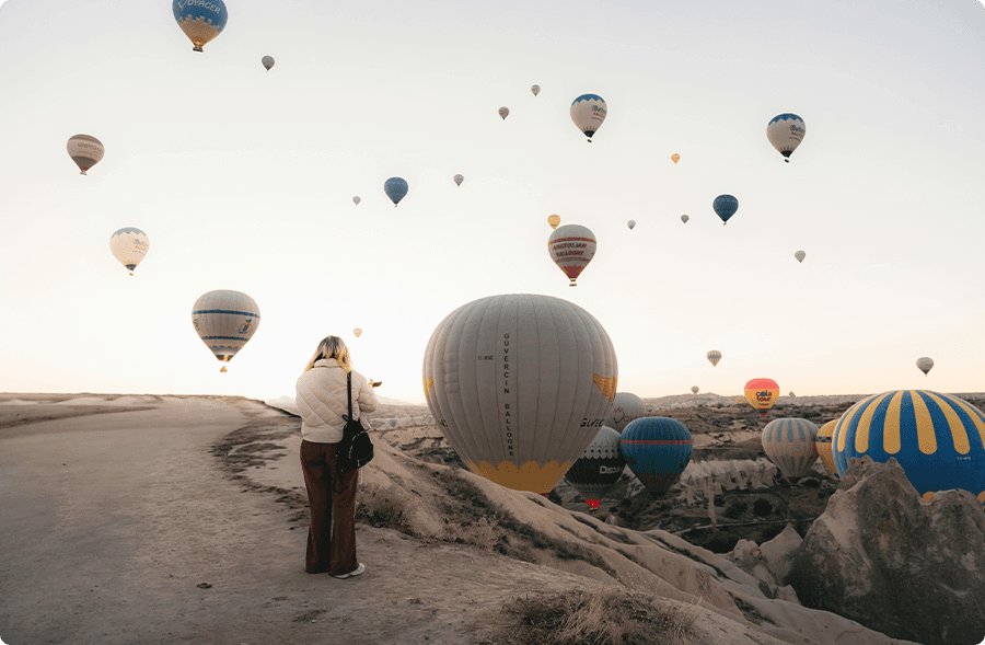 Hot air balloons over a valley at sunrise